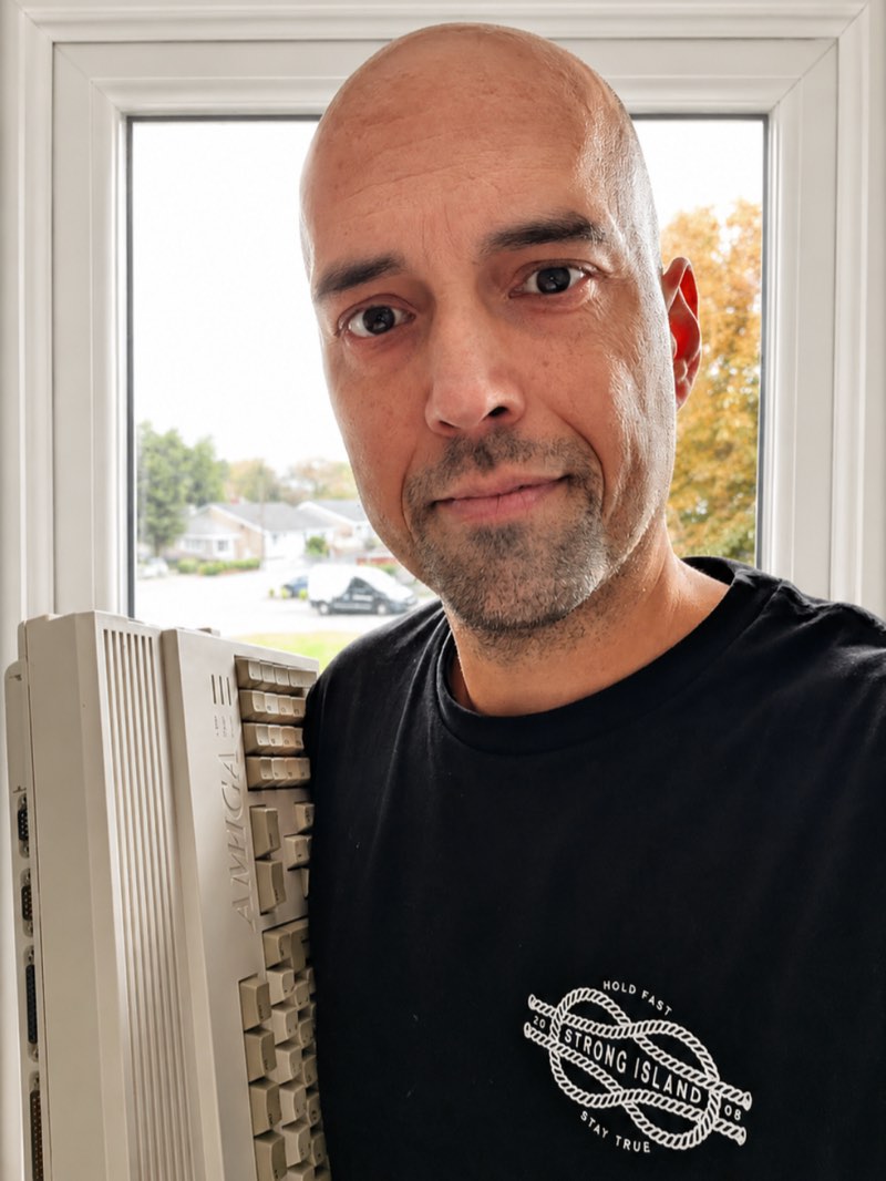 Scott Byrne-Fraser at home beside a vintage Amiga computer
